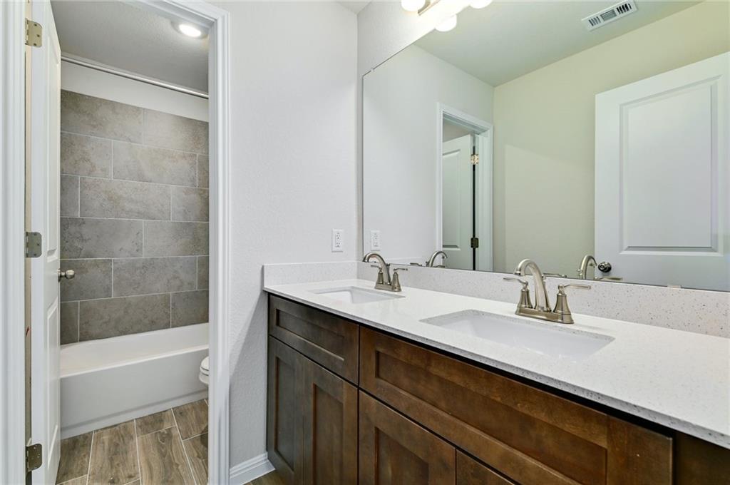 208 Evening Star Lane Georgetown, TX 78628 - Photo 17 of 26 a bathroom with a sink and a mirror