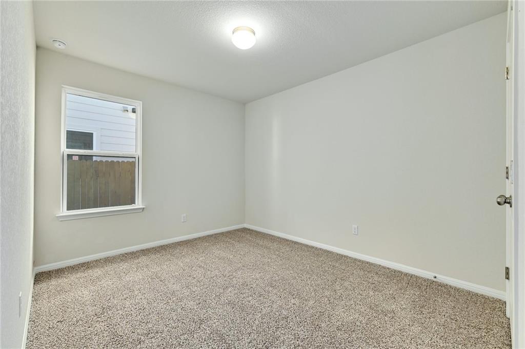 208 Evening Star Lane Georgetown, TX 78628 - Photo 18 of 26 an empty room with windows