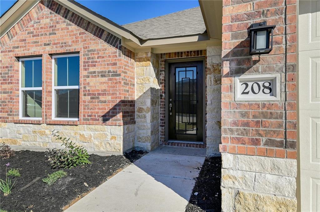 208 Evening Star Lane Georgetown, TX 78628 - Photo 2 of 26 a front view of a building with a shower and garden