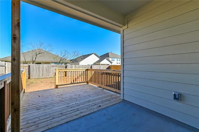 a view of a house with a wooden fence