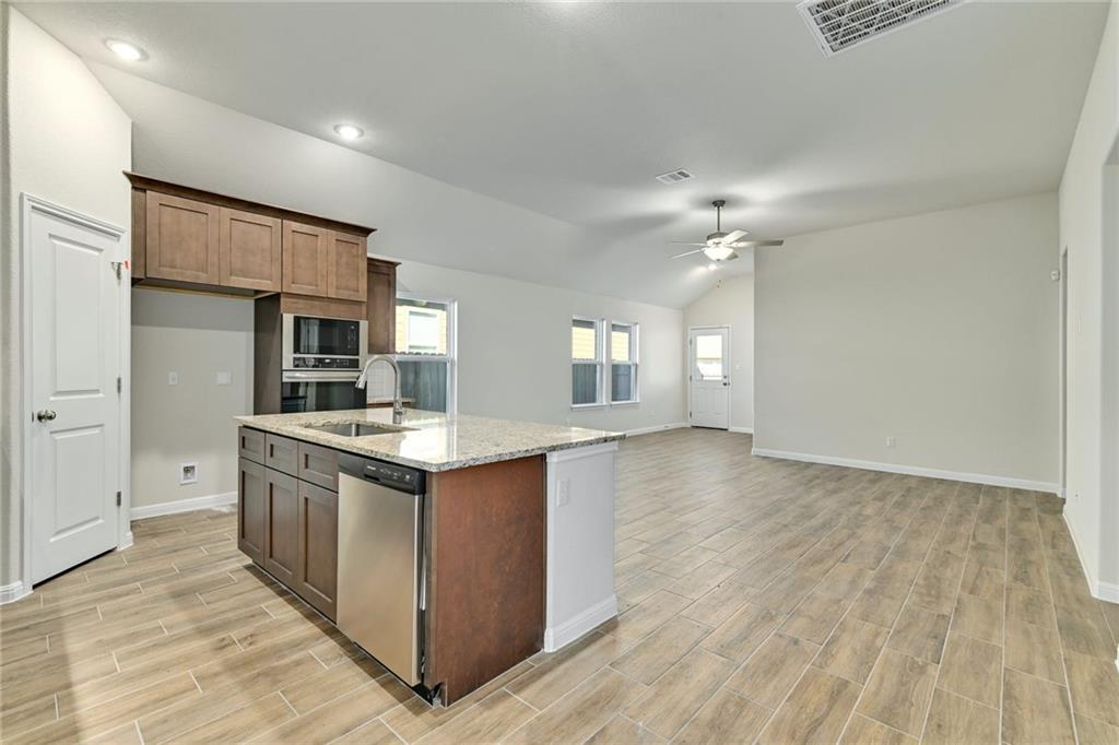 208 Evening Star Lane Georgetown, TX 78628 - Photo 26 of 26 a kitchen with stainless steel appliances granite countertop a stove and a refrigerator