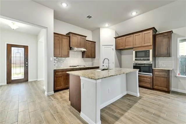a kitchen with sink and washing machine