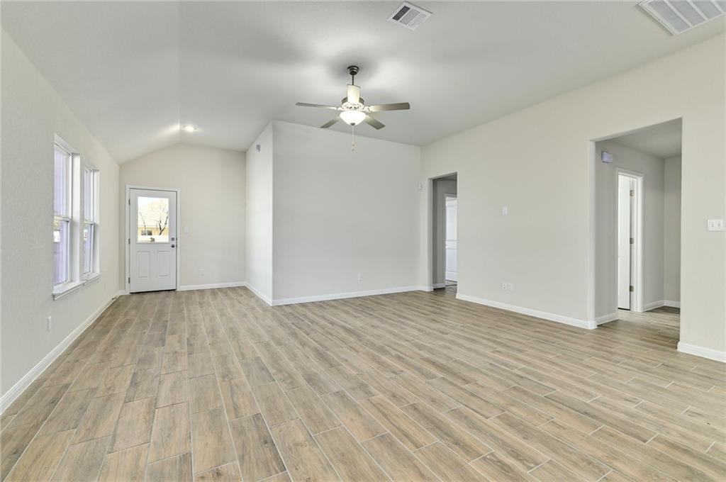 208 Evening Star Lane Georgetown, TX 78628 - Photo 9 of 26 wooden floor in an empty room with a window