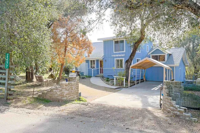 a view of a house with a yard covered in snow