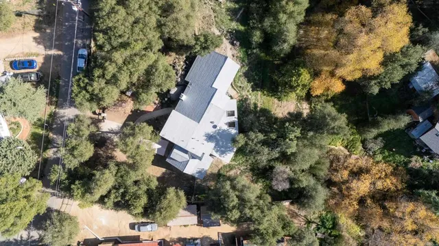 an aerial view of a house with a yard and garden