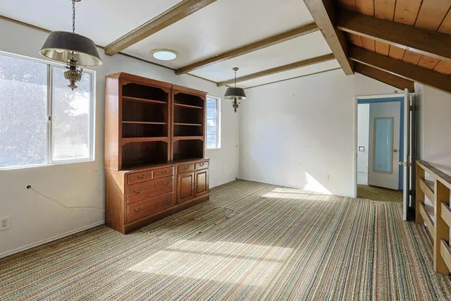 a view of a porch with wooden floor and floor to ceiling window