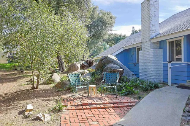 an aerial view of a house with trees all around