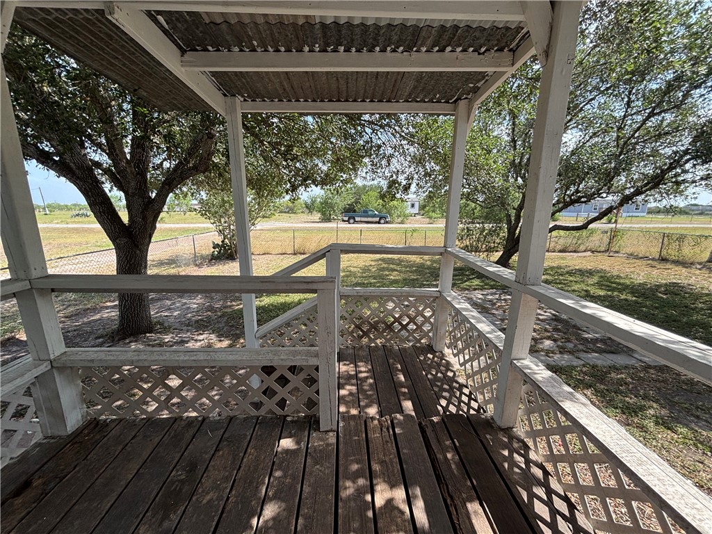 568 Jennifer Loop Orange Grove, TX 78372 - Photo 12 of 35 a view of a wooden deck and a yard