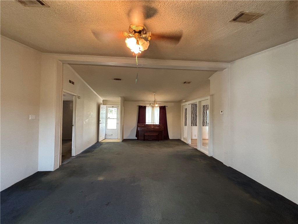 568 Jennifer Loop Orange Grove, TX 78372 - Photo 13 of 35 a view of a big room with windows and chandelier fan