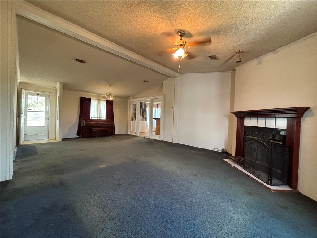 568 Jennifer Loop Orange Grove, TX 78372 - Photo 14 of 35 a view of an empty room with a fireplace and chandelier