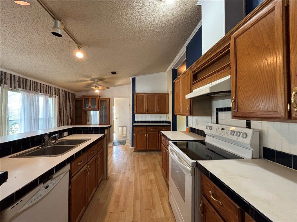 568 Jennifer Loop Orange Grove, TX 78372 - Photo 25 of 35 a kitchen with stainless steel appliances granite countertop a sink stove and refrigerator