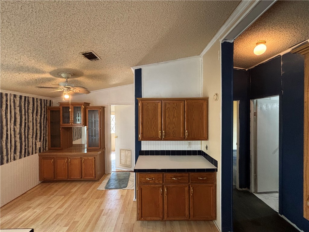 568 Jennifer Loop Orange Grove, TX 78372 - Photo 26 of 35 a view of a refrigerator in kitchen and wooden floor