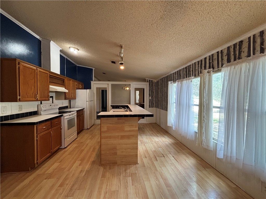 568 Jennifer Loop Orange Grove, TX 78372 - Photo 27 of 35 a large kitchen with lots of counter space and stainless steel appliances