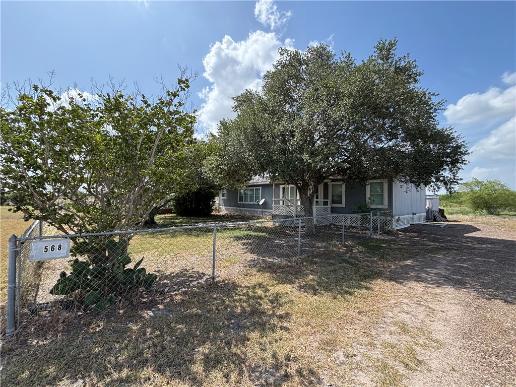568 Jennifer Loop Orange Grove, TX 78372 - Photo 4 of 35 a front view of a house with a yard
