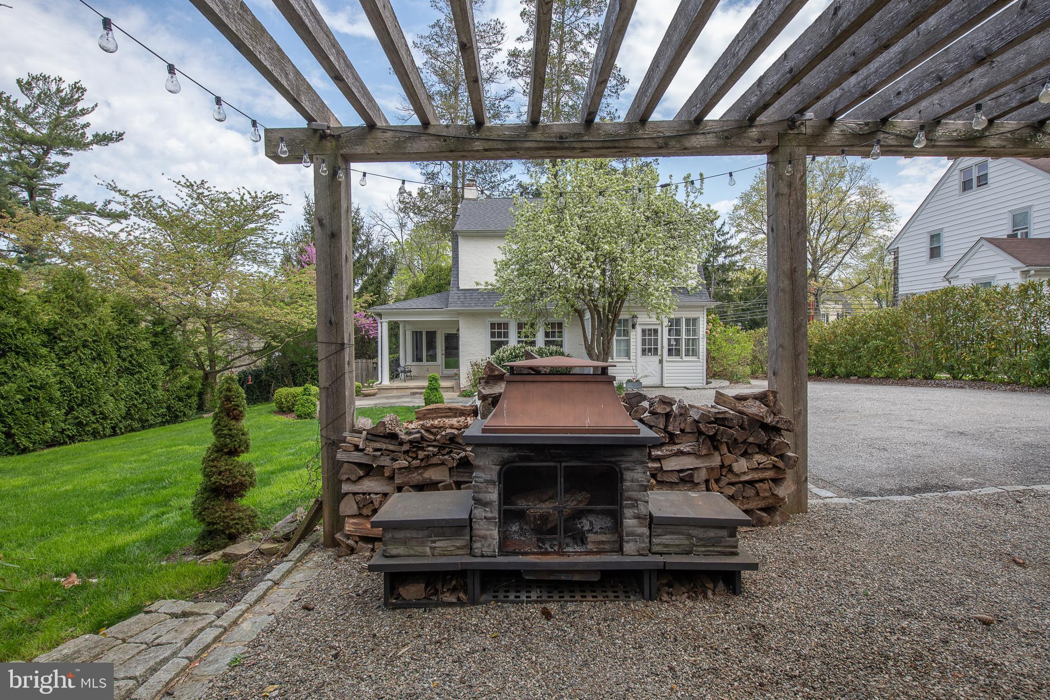 778 Upper Gulph Road Wayne, PA 19087 - Photo 35 of 36 Backyard pergola with stone freestanding fireplace