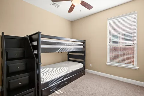 a bedroom with a bed and a window