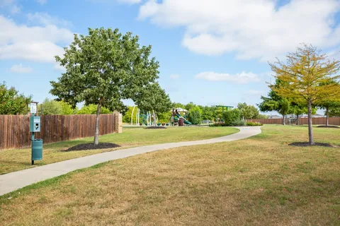 a view of yard with swimming pool and green space