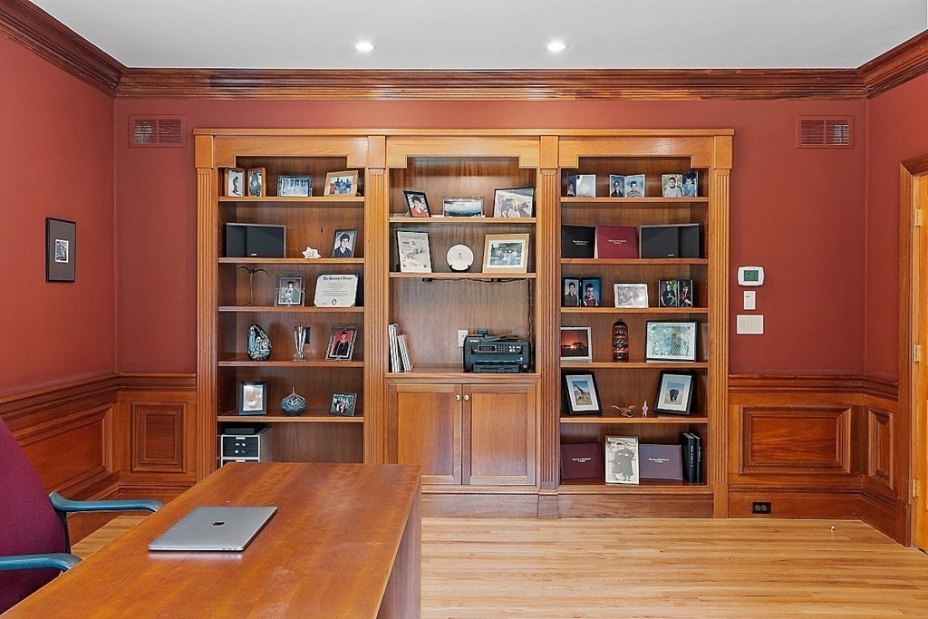 166 Tower Road Lincoln, MA 01773 - Photo 18 of 39 a living room with bookshelf and wooden floor