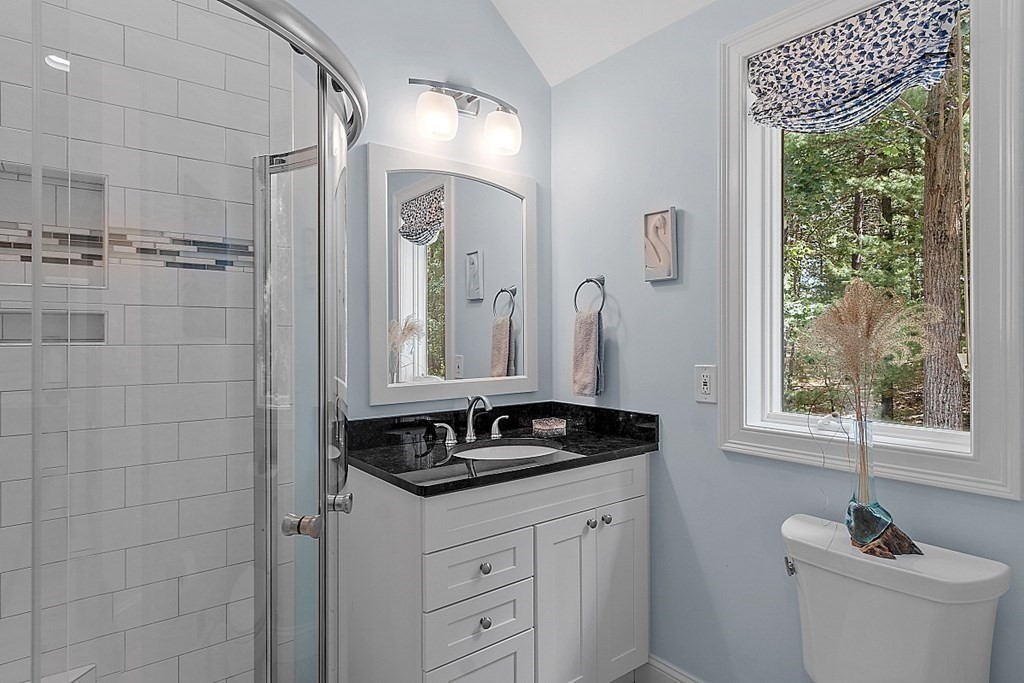 166 Tower Road Lincoln, MA 01773 - Photo 21 of 39 a bathroom with a granite countertop sink a toilet a window and shower