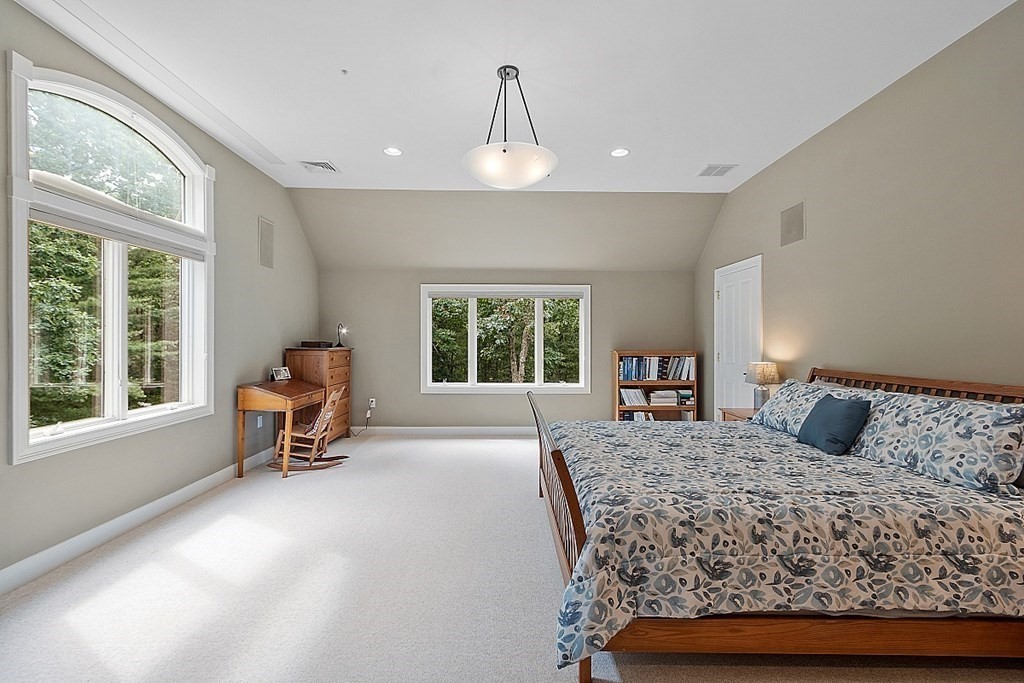 166 Tower Road Lincoln, MA 01773 - Photo 23 of 39 a bedroom with a bed a table and windows