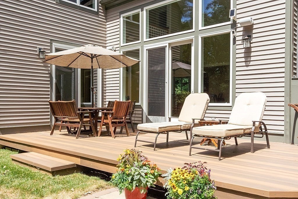 166 Tower Road Lincoln, MA 01773 - Photo 34 of 39 a view of a dinning table and chairs in the patio in front of a house