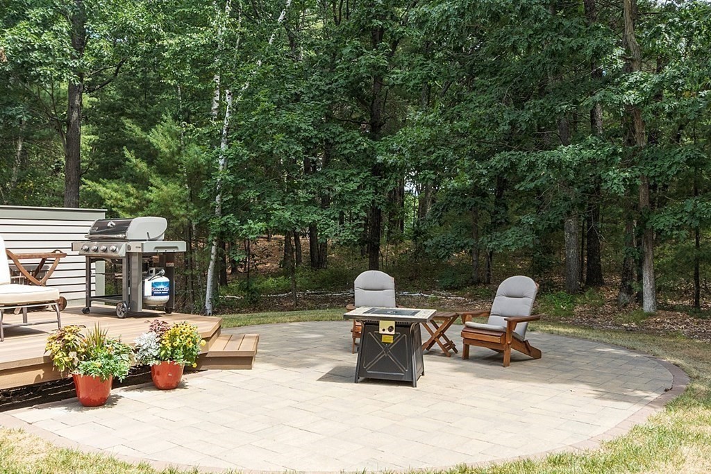 166 Tower Road Lincoln, MA 01773 - Photo 36 of 39 a view of a patio with table and chairs potted plants and a large tree