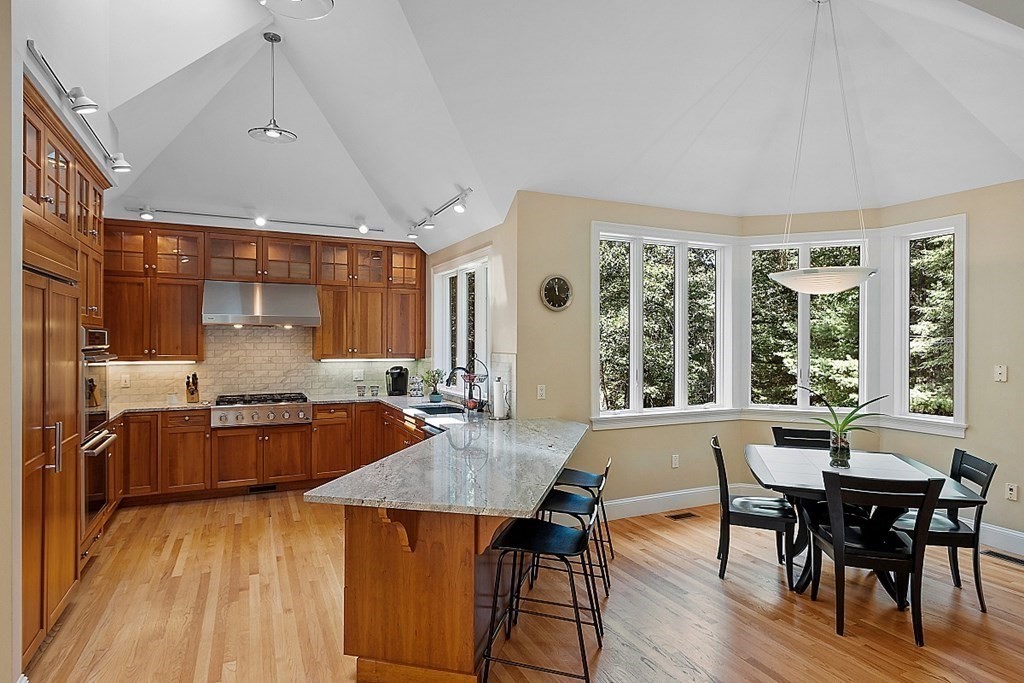 166 Tower Road Lincoln, MA 01773 - Photo 6 of 39 a kitchen with a table chairs stove and wooden floor