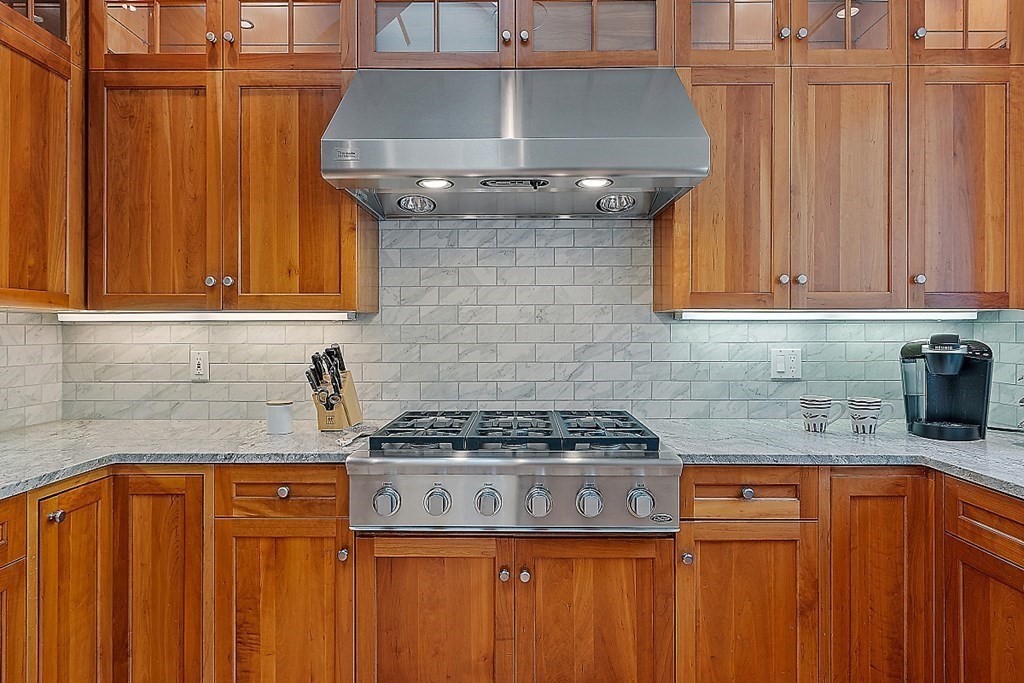 166 Tower Road Lincoln, MA 01773 - Photo 8 of 39 a kitchen with granite countertop a stove top oven a sink dishwasher and cabinets with wooden floor