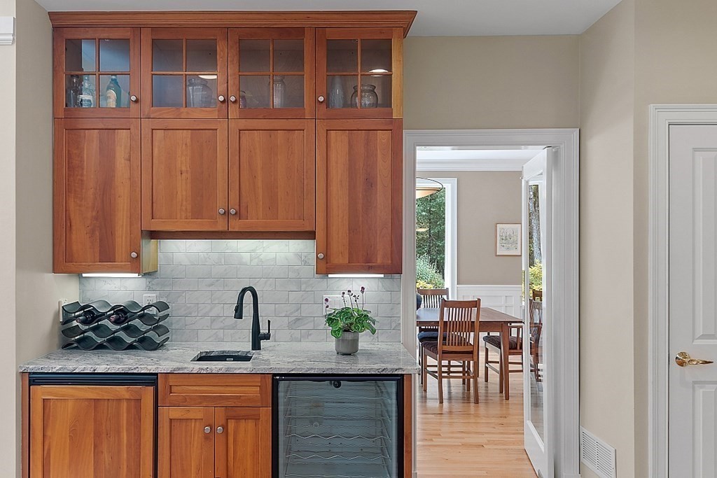 166 Tower Road Lincoln, MA 01773 - Photo 9 of 39 a kitchen with granite countertop wooden cabinets and dining table