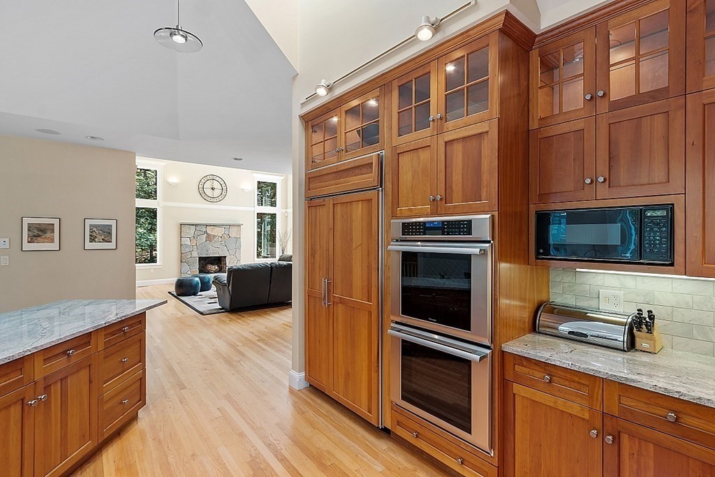 166 Tower Road Lincoln, MA 01773 - Photo 10 of 39 a kitchen with furniture and a fireplace