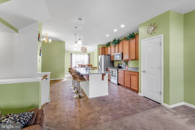 a kitchen with a refrigerator and a wooden cabinets