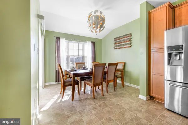 a view of a dining room with furniture and a chandelier
