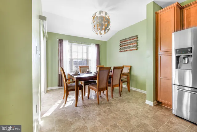 a view of a dining room with furniture and a chandelier