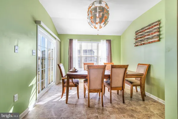 a view of a dining room with furniture and a chandelier