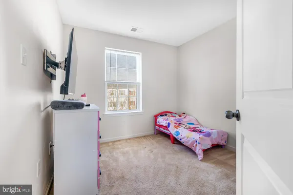 an empty room with furniture and flat screen tv