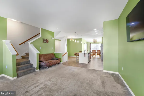 a lobby with furniture and stairs
