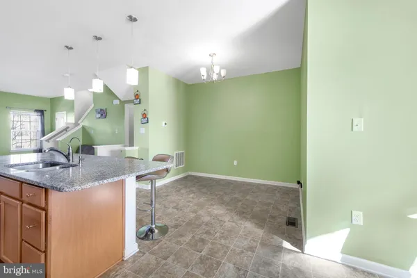 a bathroom with a granite countertop sink a mirror and a shower