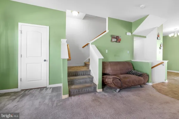 a living room with furniture and a stairs