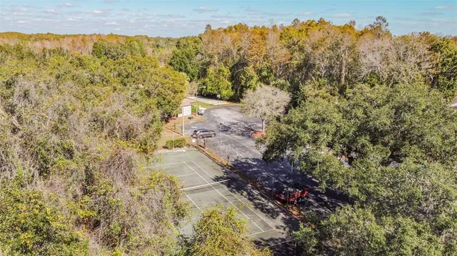 a view of a covered with trees in front of house
