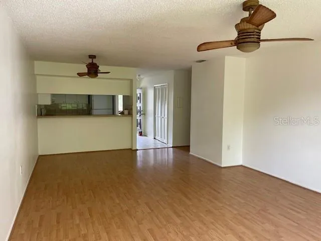 a view of a livingroom with a kitchen and a dishwasher wooden floor
