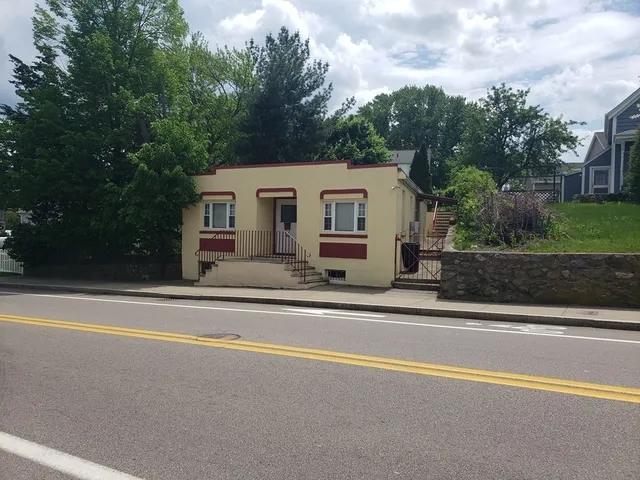 a view of a house with a swimming pool and a trees