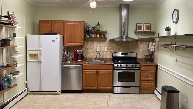 a kitchen with stainless steel appliances granite countertop a stove a refrigerator and a sink