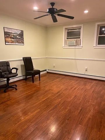 a living room with wooden floor and furniture