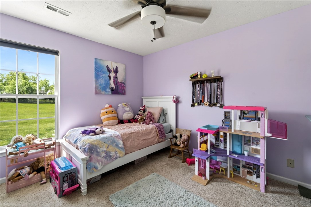 39 Holly Court Springboro, OH 45066 - Photo 23 of 42 This cozy bedroom features a large window offering expansive views of the outdoors.