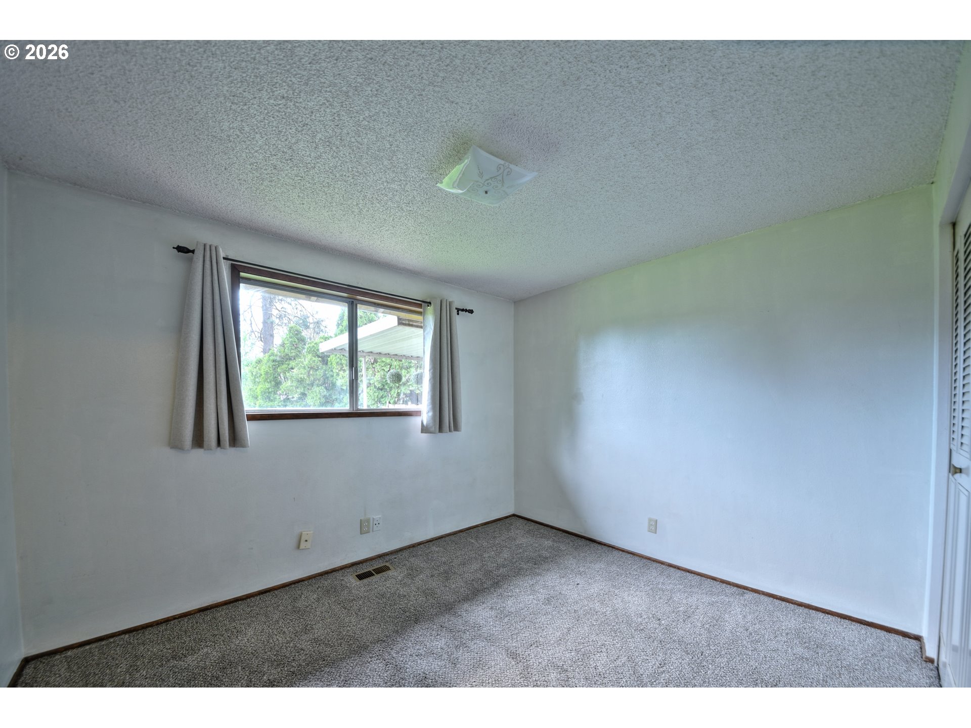 1798 Gilham Road Eugene, OR 97401 - Photo 14 of 30 a view of an empty room with a window