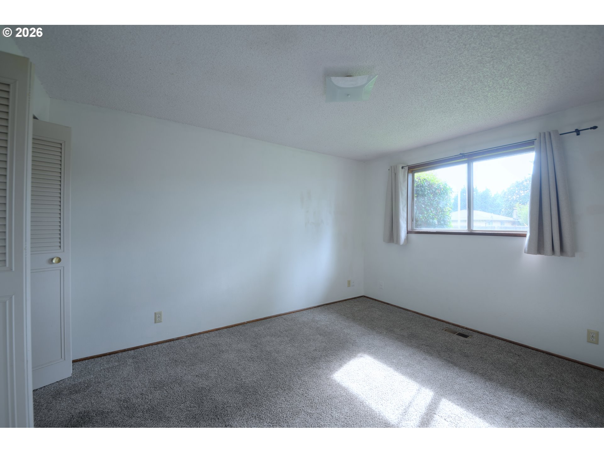 1798 Gilham Road Eugene, OR 97401 - Photo 16 of 30 a view of an empty room and window