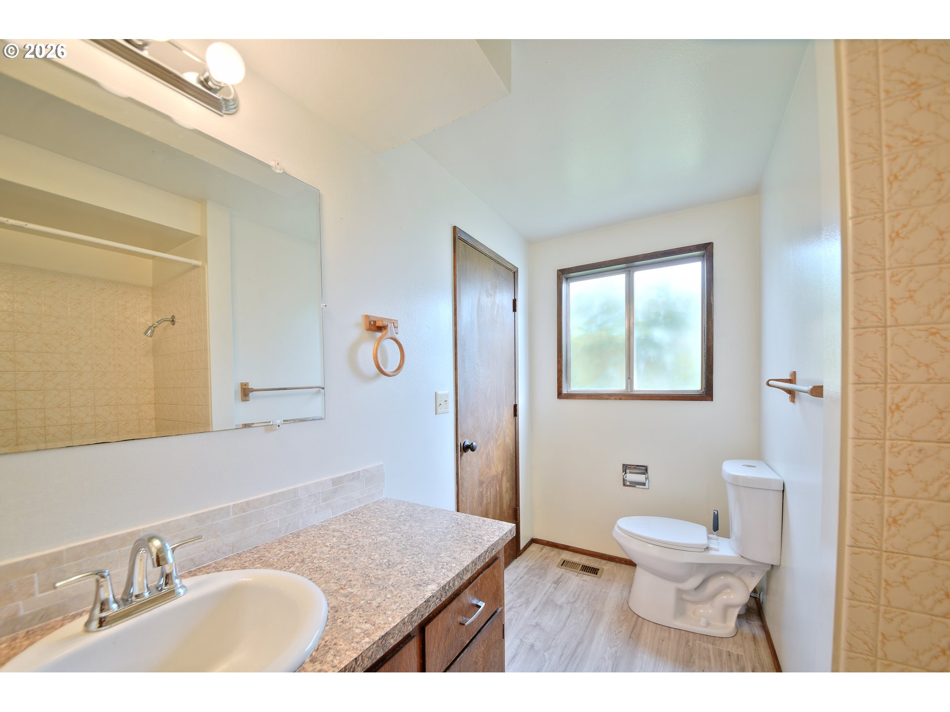 1798 Gilham Road Eugene, OR 97401 - Photo 18 of 30 a bathroom with a granite countertop sink a toilet and a mirror