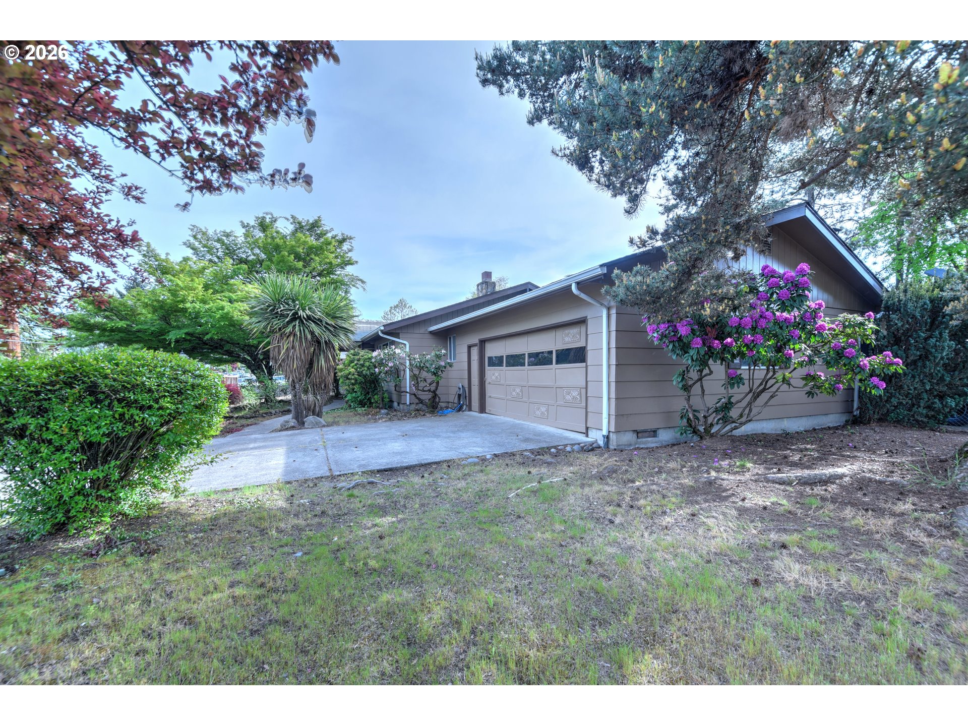 1798 Gilham Road Eugene, OR 97401 - Photo 29 of 30 a front view of a house with a yard and garage