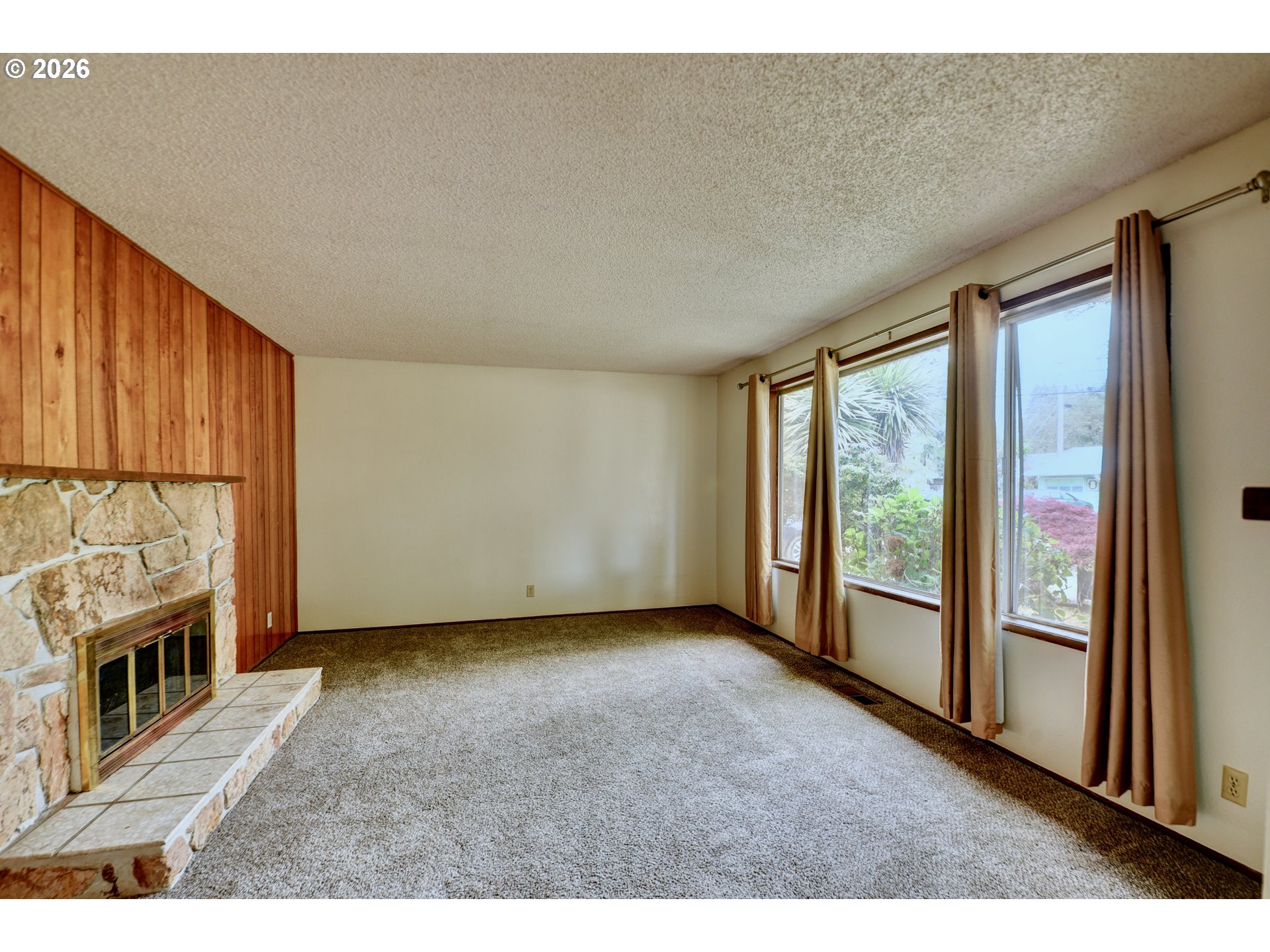1798 Gilham Road Eugene, OR 97401 - Photo 3 of 30 a view of an empty room with a fireplace