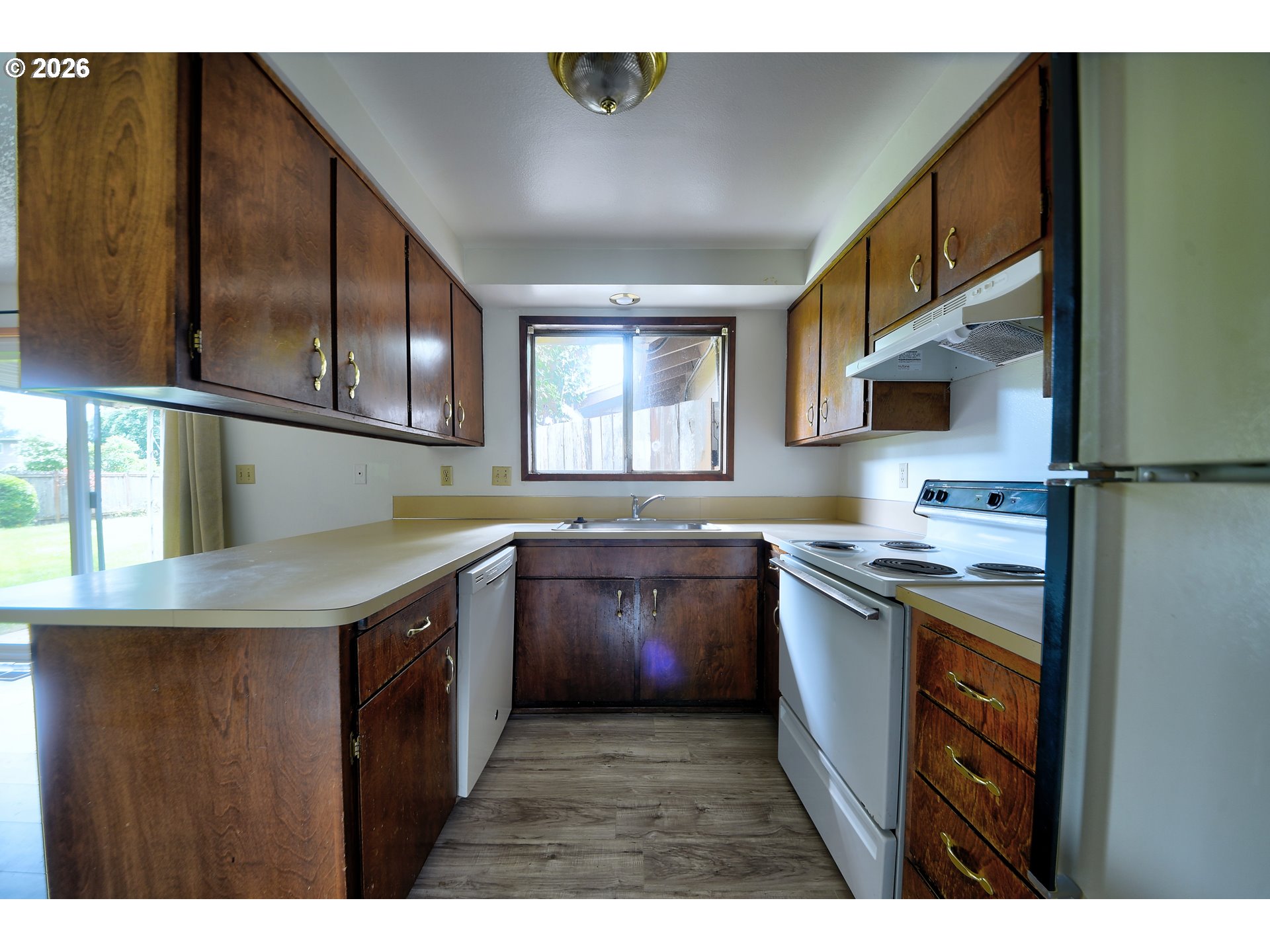1798 Gilham Road Eugene, OR 97401 - Photo 10 of 30 a kitchen with kitchen island granite countertop a sink window and stainless steel appliances